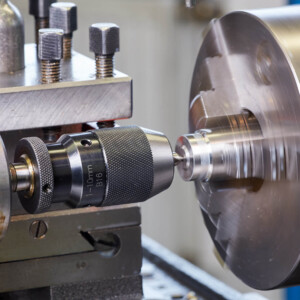 metal lathe drilling a rotating workpiece