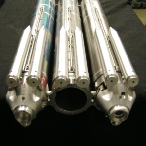 Triple-barreled metallic device close-up.